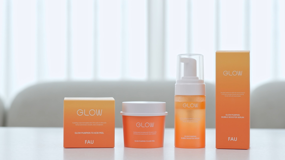 FAU Glow Pumpkin 7.0 Acid Peel cream and Glow Pumpkin Bubble Booster Serum with their product boxes on a white table.